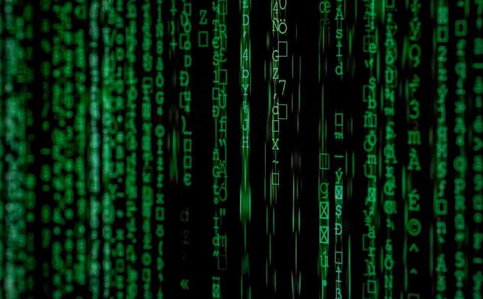 Matrix-style green digital code on black background representing cybersecurity threats and AI-powered cyber attacks in 2026
